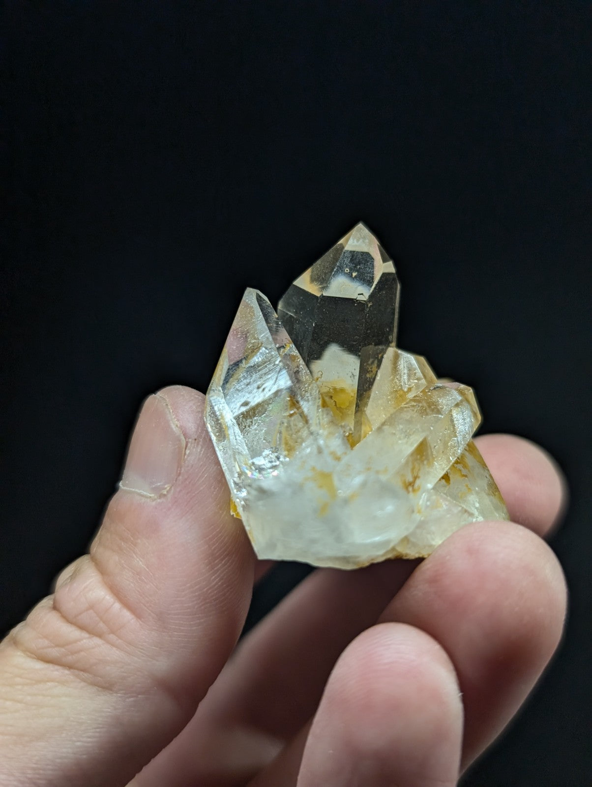 A translucent, pale yellow quartz crystal cluster with sharp facets and subtle internal inclusions.