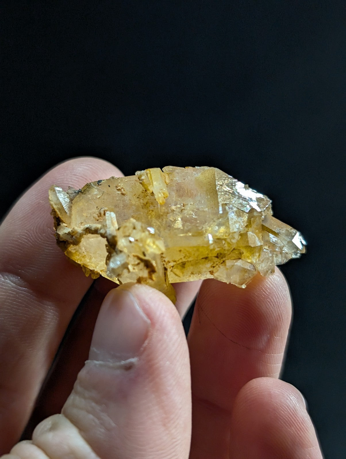 A translucent golden-yellow crystal cluster with sharp, faceted edges and a slightly rough texture.