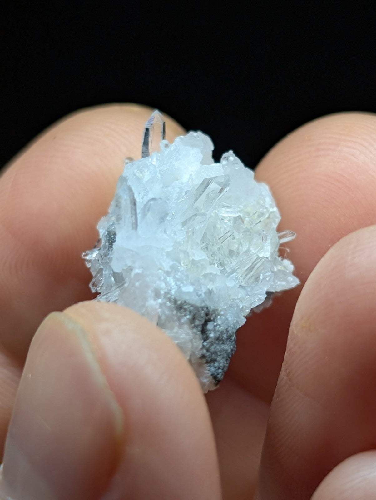 A translucent, crystalline mineral specimen with sharp, jagged edges and a pale blue hue.