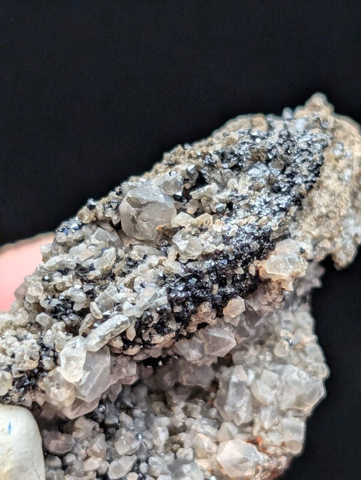Cluster of clear quartz crystals with black inclusions.
