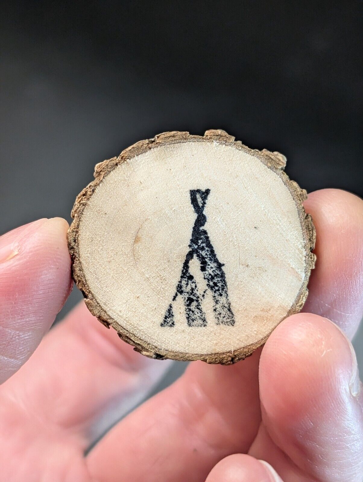 Wood slice with teepee design.