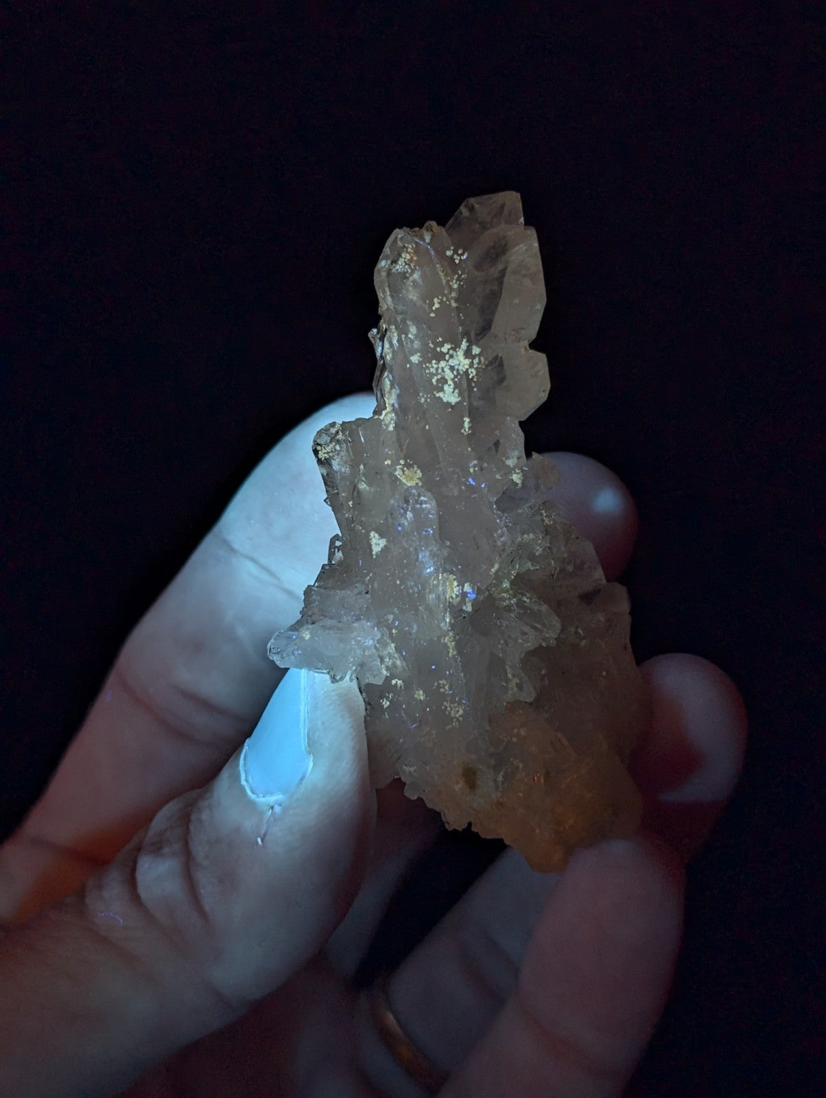 A translucent, amber-hued crystal cluster with golden mineral inclusions and a rough, jagged surface.