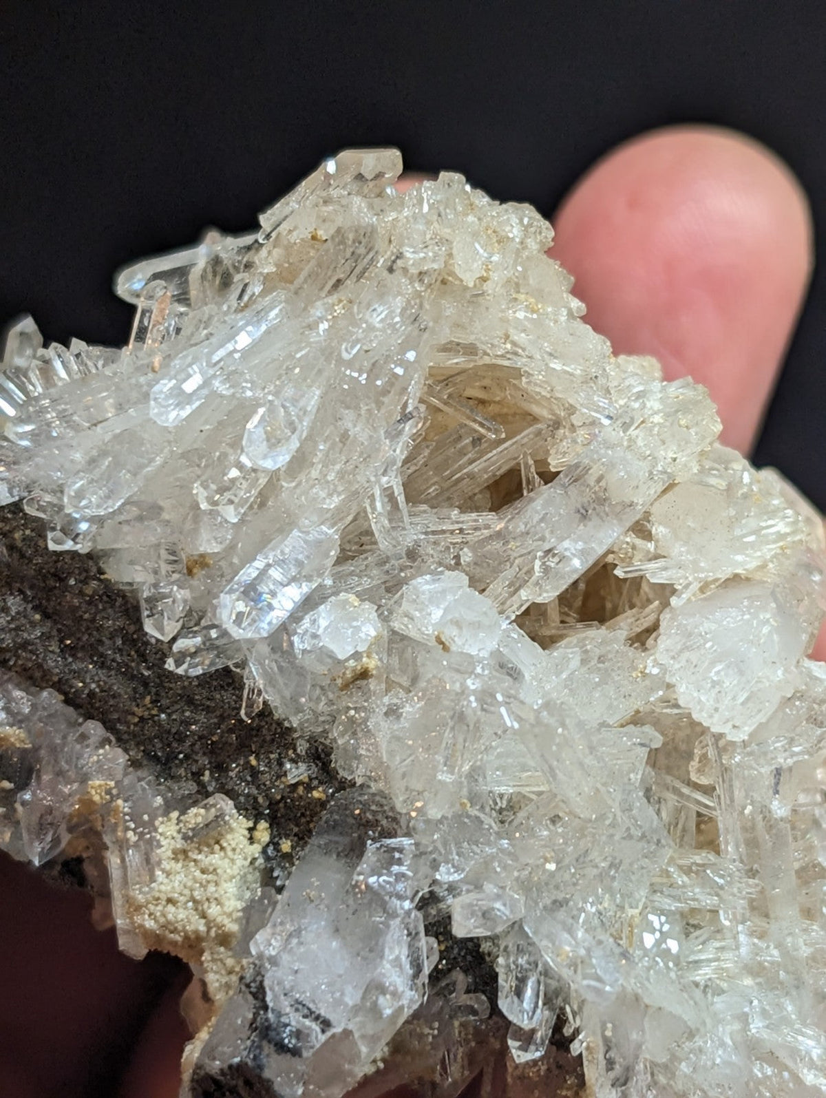 A cluster of transparent, crystalline quartz formations with sharp edges and facets.
