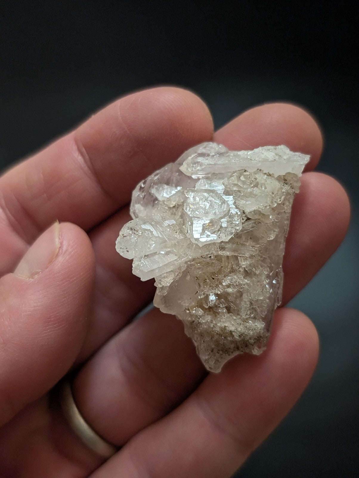 A translucent, crystalline quartz specimen with a rough, jagged surface and visible internal inclusions.