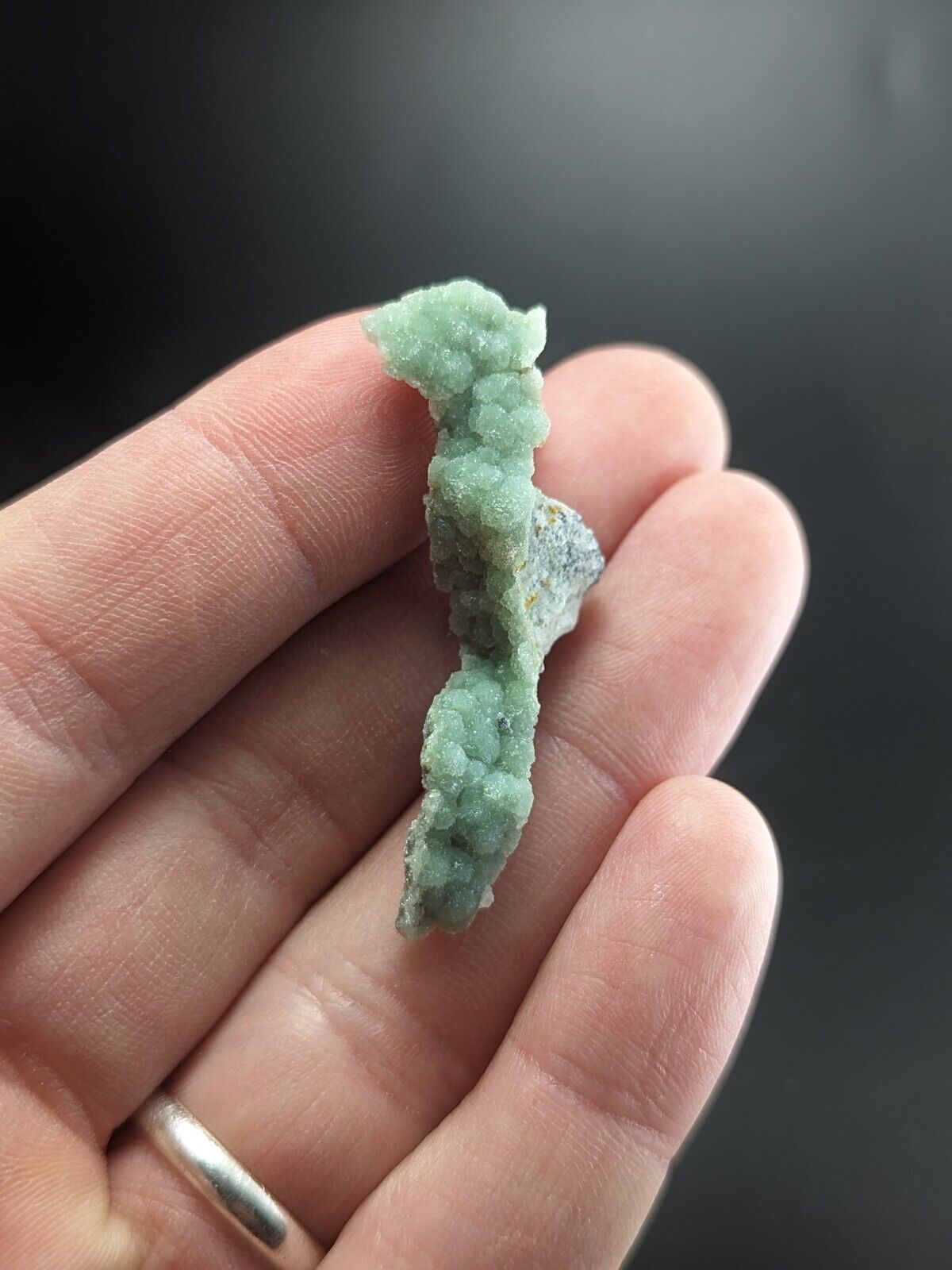 Green crystalline mineral specimen.