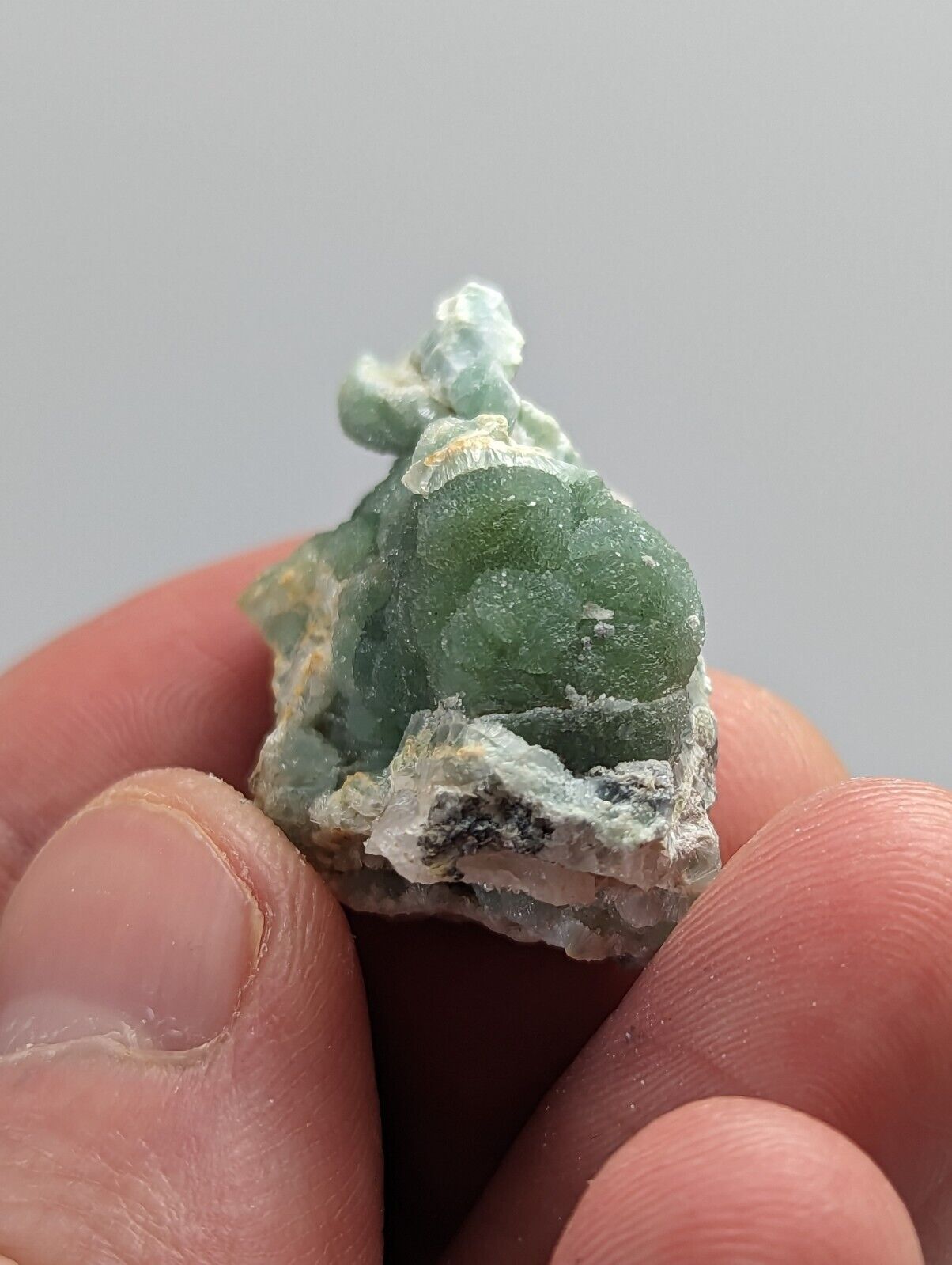 Green botryoidal mineral specimen.