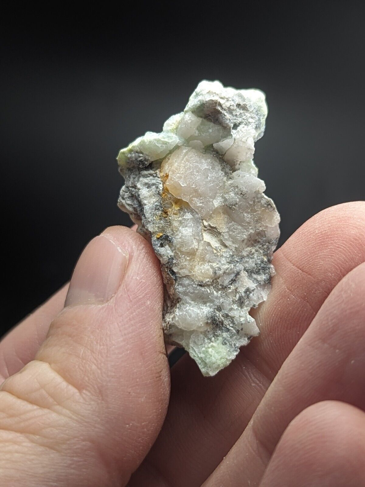 Rough mineral specimen with crystalline structures.