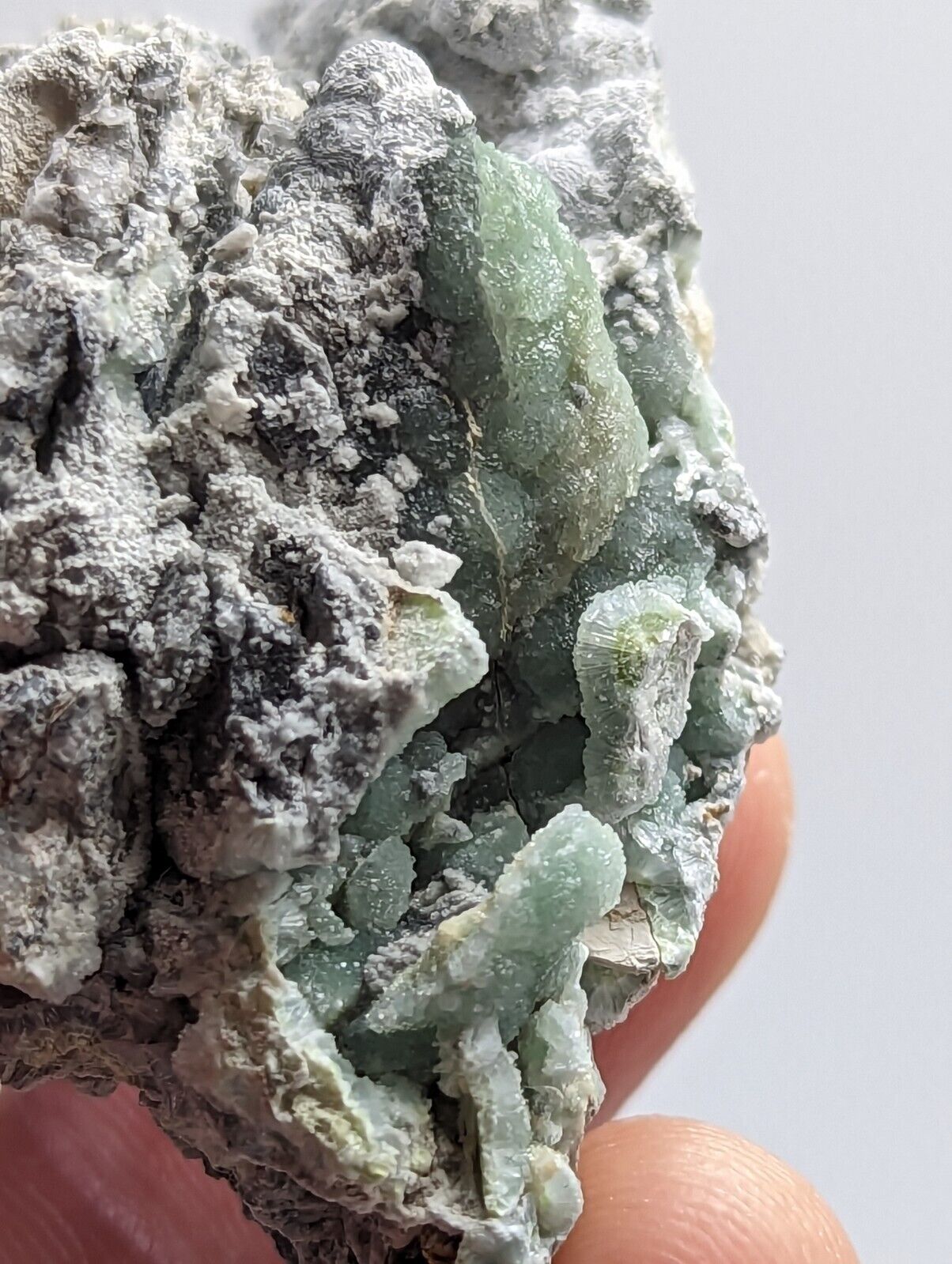 Green crystalline mineral specimen.