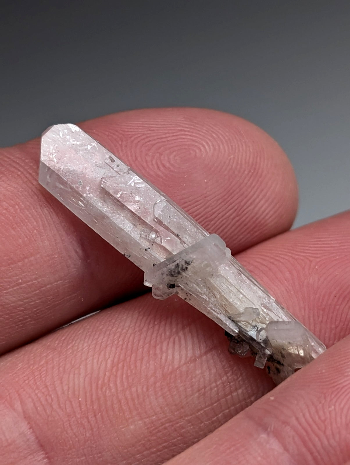 A+ barite crystal from chamberlain creek arkansas with clear quartz and dark inclusions in a display case