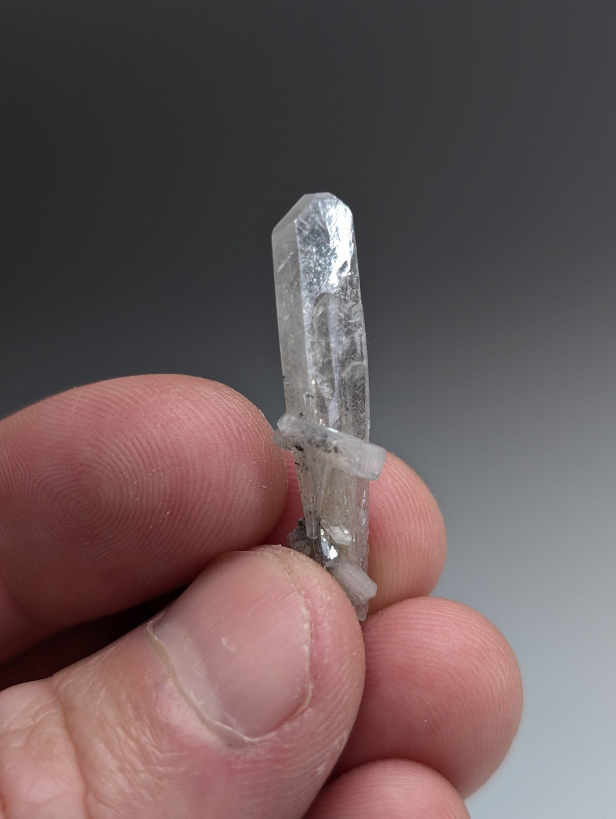 A clear translucent quartz barite crystal with pointed tip and internal inclusions from chamberlain creek Arkansas