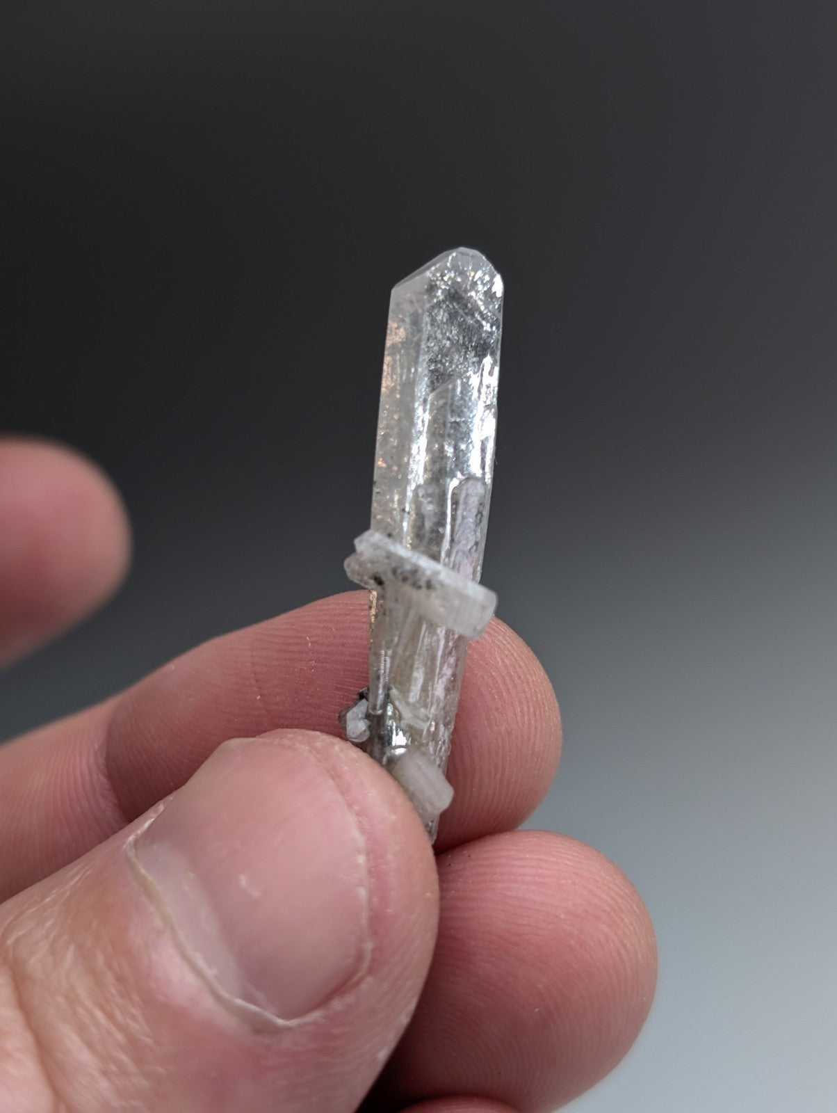 A clear translucent quartz crystal with pointed tip and inclusions from A+ barite crystal Arkansas with case