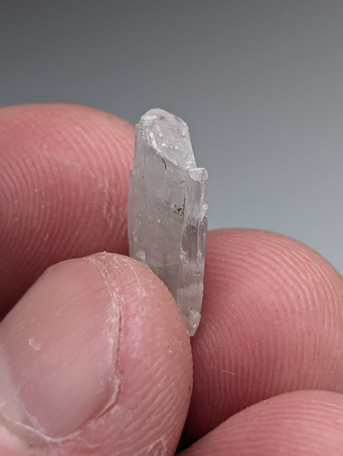A translucent clear quartz barite crystal with a rough top and smooth sides from magnet cove arkansas with case