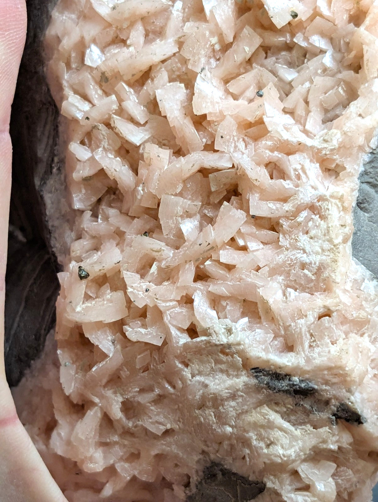 A cluster of translucent pink crystals with a crystalline, jagged texture.