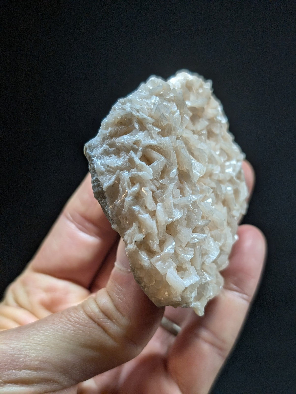 A translucent, pale quartz crystal cluster with a rough, jagged surface and delicate, interlocking facets.