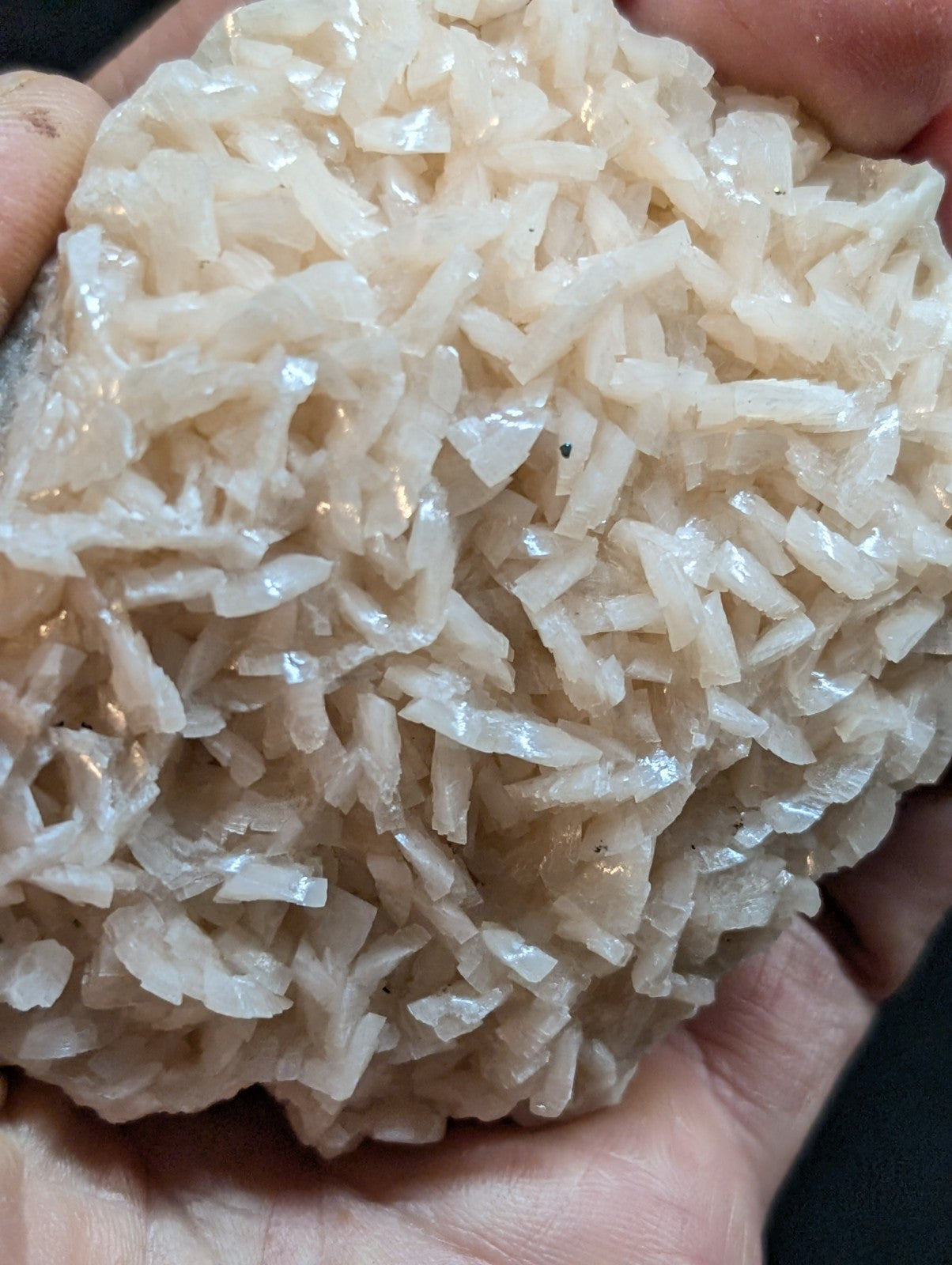 A translucent, off-white mineral specimen with jagged, crystalline fragments clustered together.