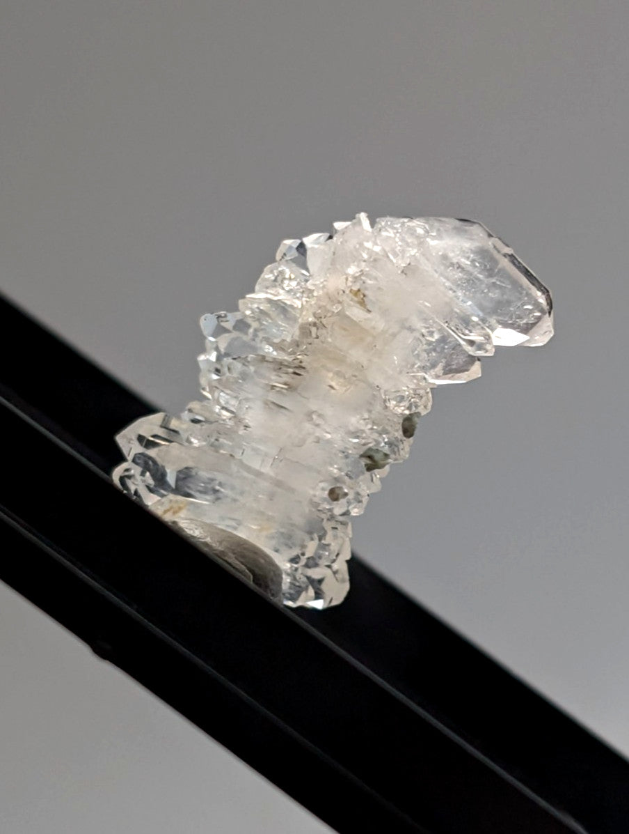 A+ faden quartz crystal with translucent jagged edges and layered structure in photo case from saline county arkansas usa