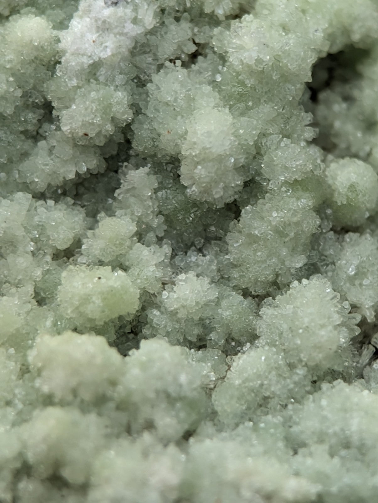 A cluster of pale green translucent fluorwavellite crystals intermixed with SiO2 from Mauldin Mountain Arkansas
