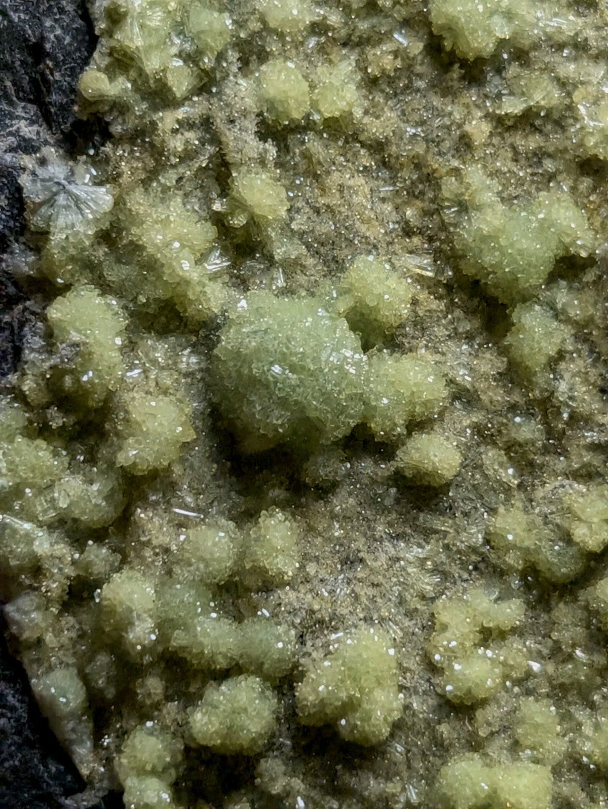 Green, crystalline mineral formations with a granular texture.