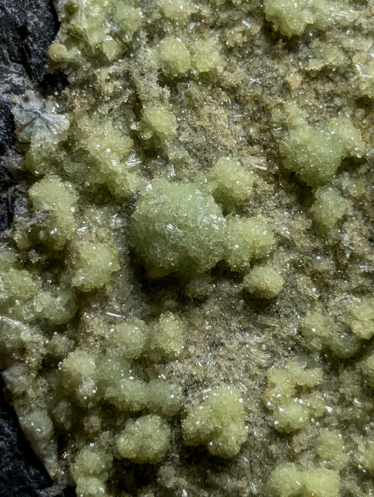 Green, crystalline mineral formations with a granular texture.