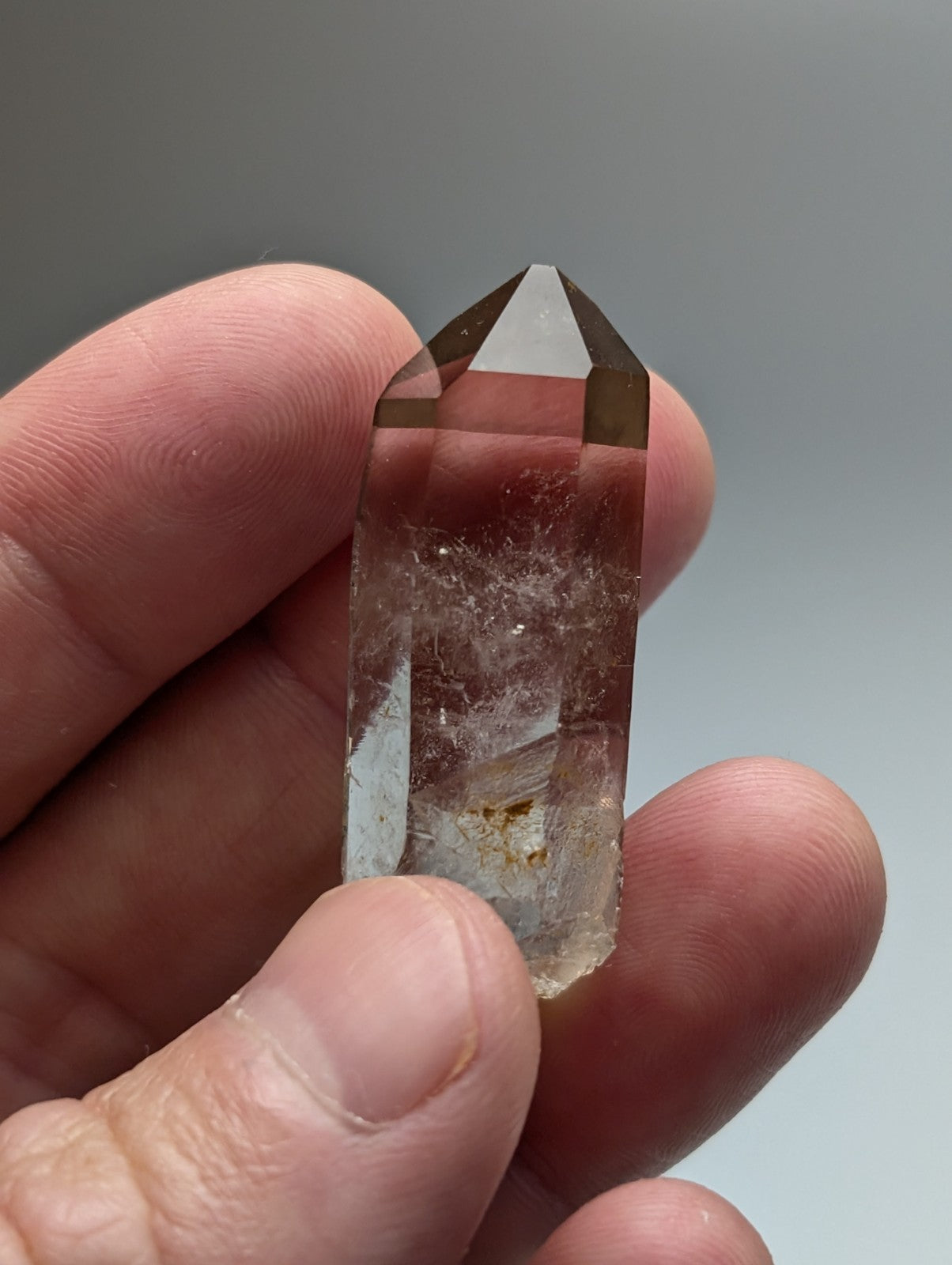 A a plus plus natural smoky quartz crystal point from garland county arkansas usa with translucent smoky color and internal inclusions held gently