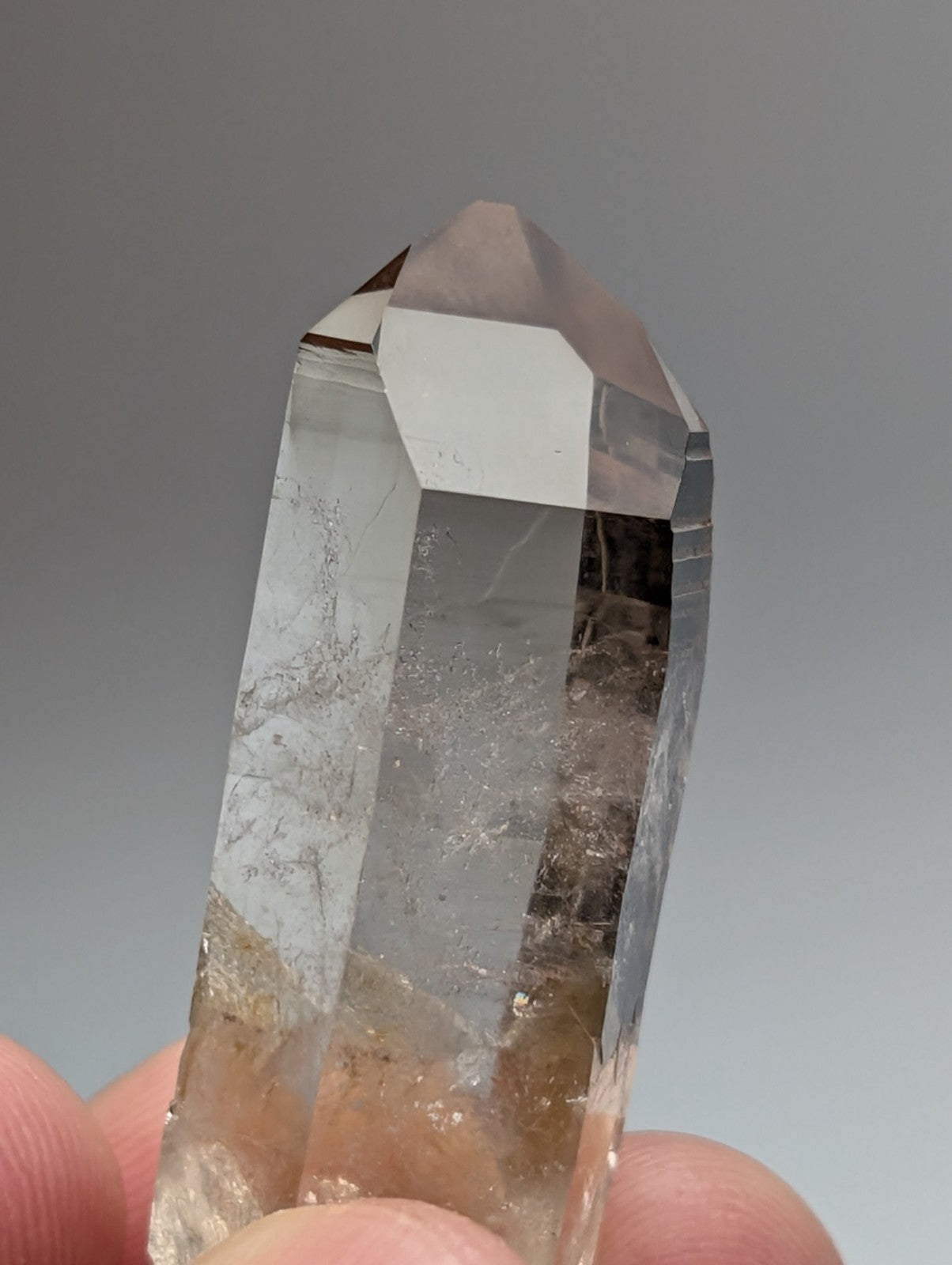 A+++ natural smoky quartz crystal point with clear faceted surface and golden inclusions from Garland County Arkansas