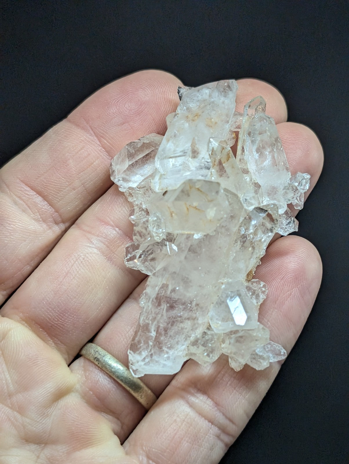 A translucent, clear quartz crystal cluster with natural facets and subtle internal inclusions.