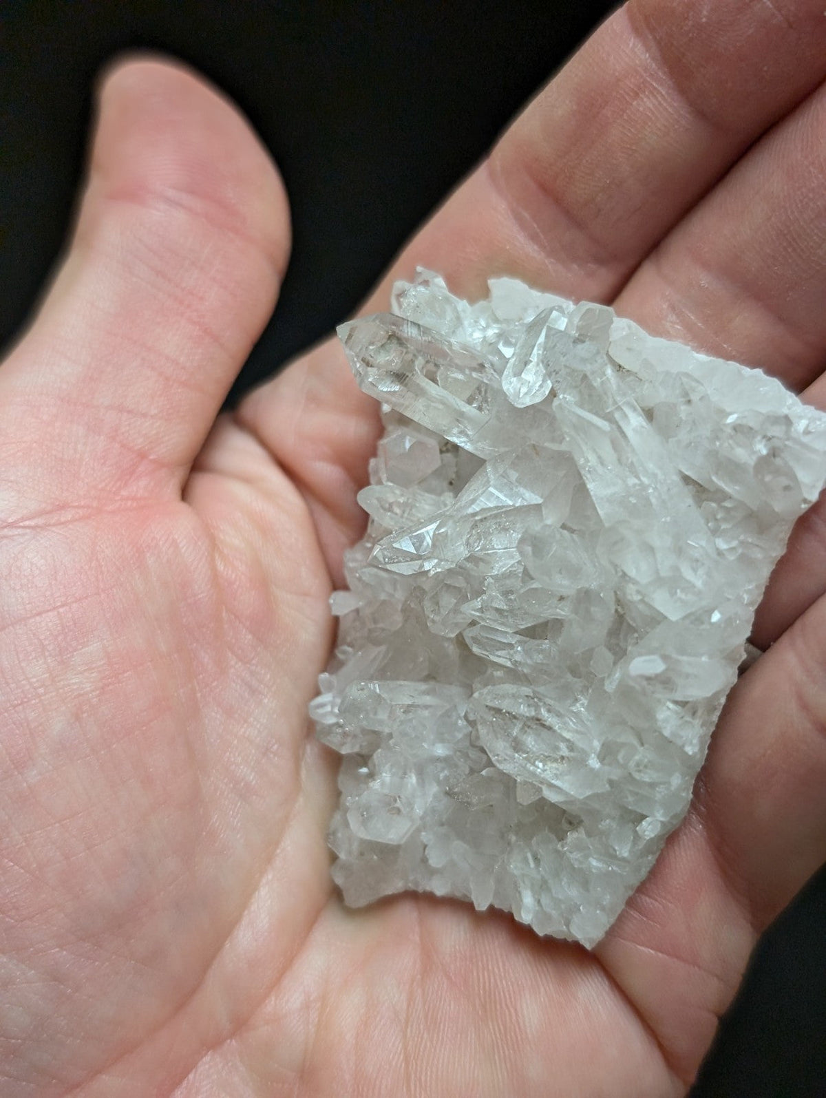 A translucent, clear quartz crystal cluster with jagged edges and a natural, irregular shape.