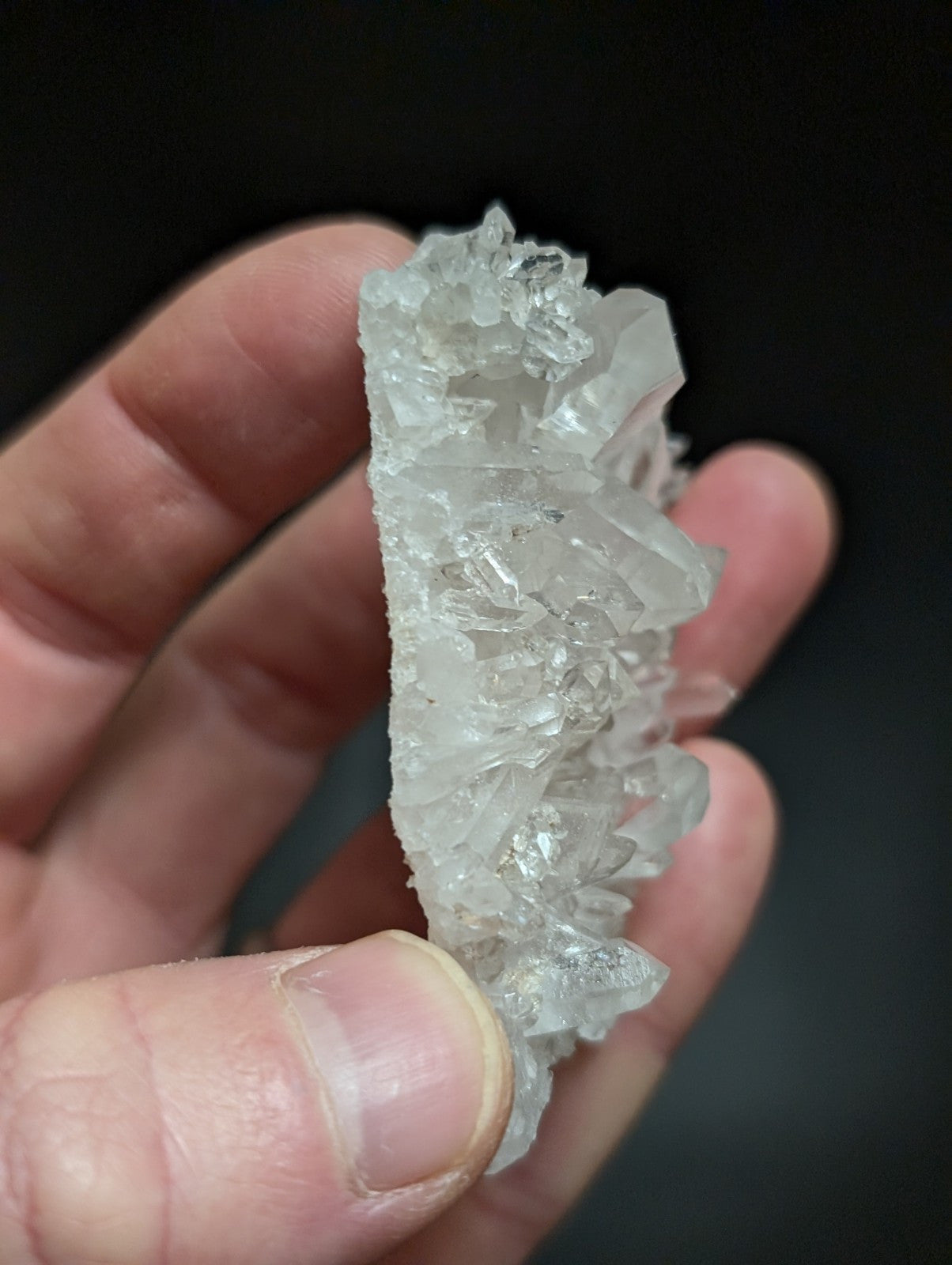 A translucent, clear quartz crystal cluster with sharp, jagged edges and a natural, irregular formation.