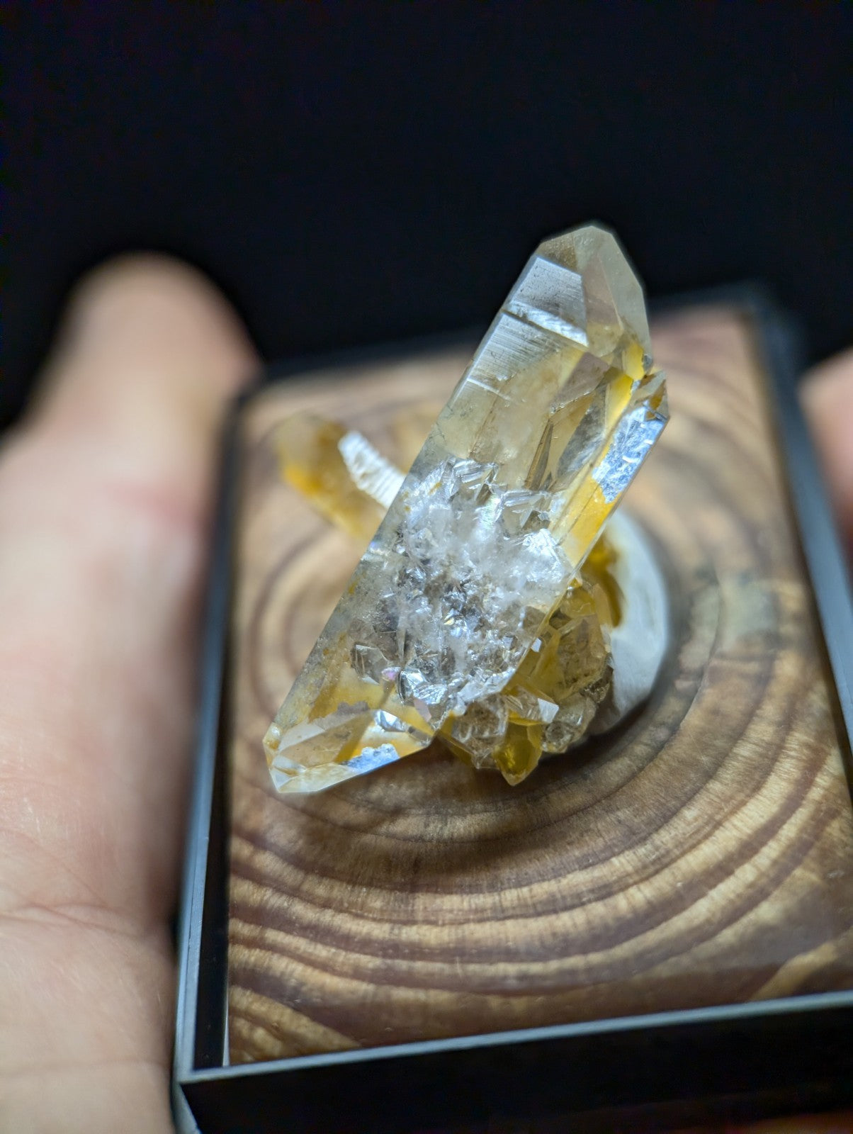 A translucent yellow and clear quartz crystal cluster with a natural, faceted structure.