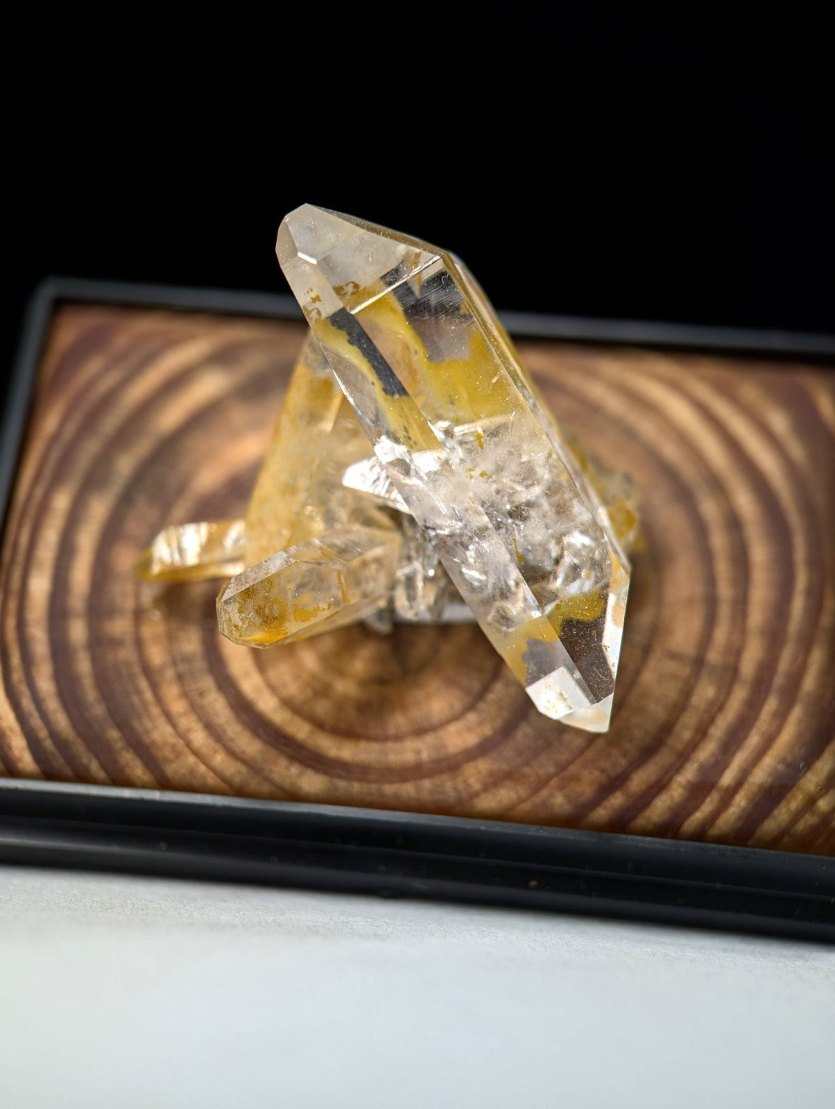 A translucent yellow and clear quartz crystal cluster with sharp, faceted points.