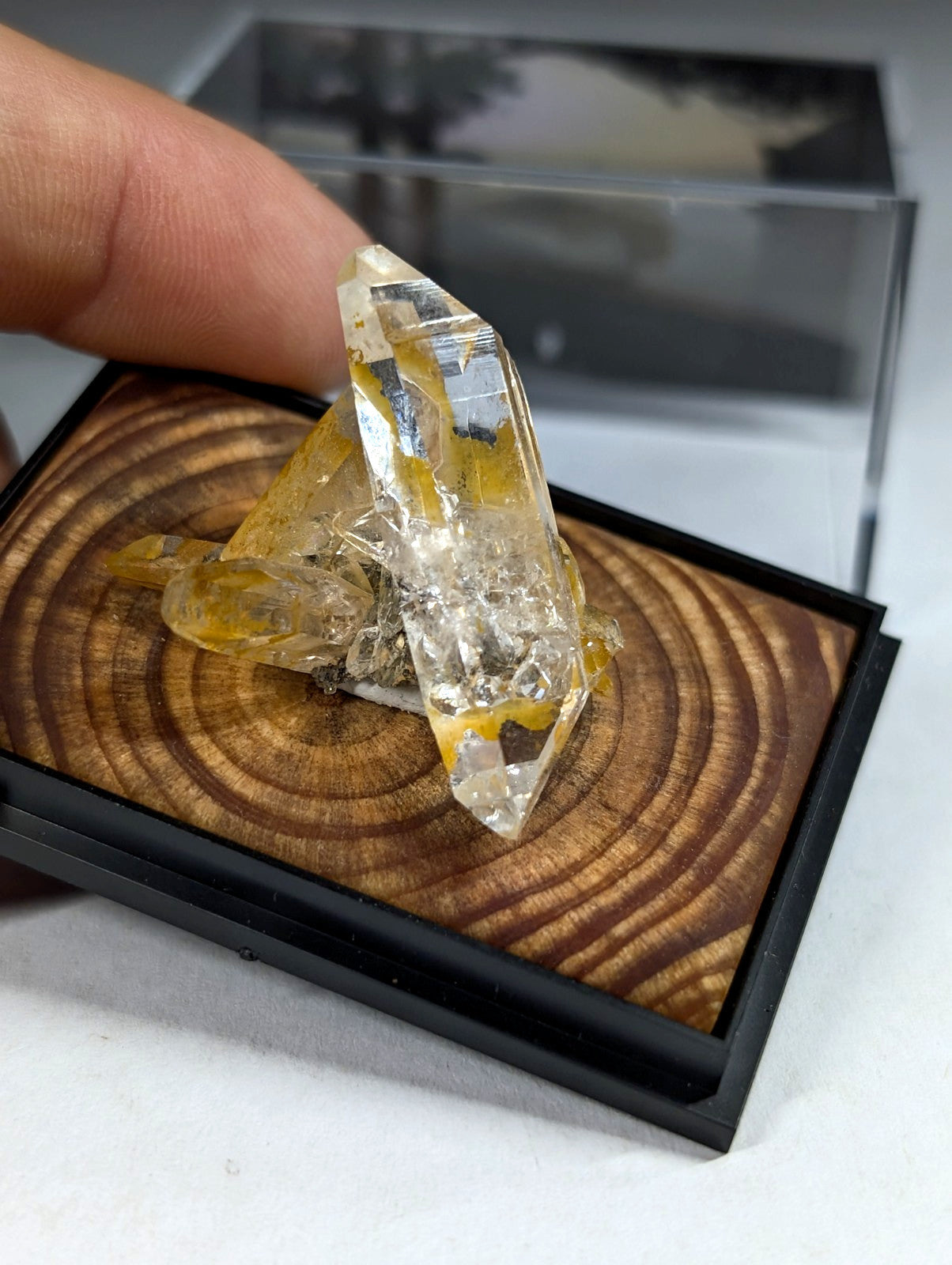 A translucent yellow and clear quartz crystal cluster with a pointed, faceted structure.