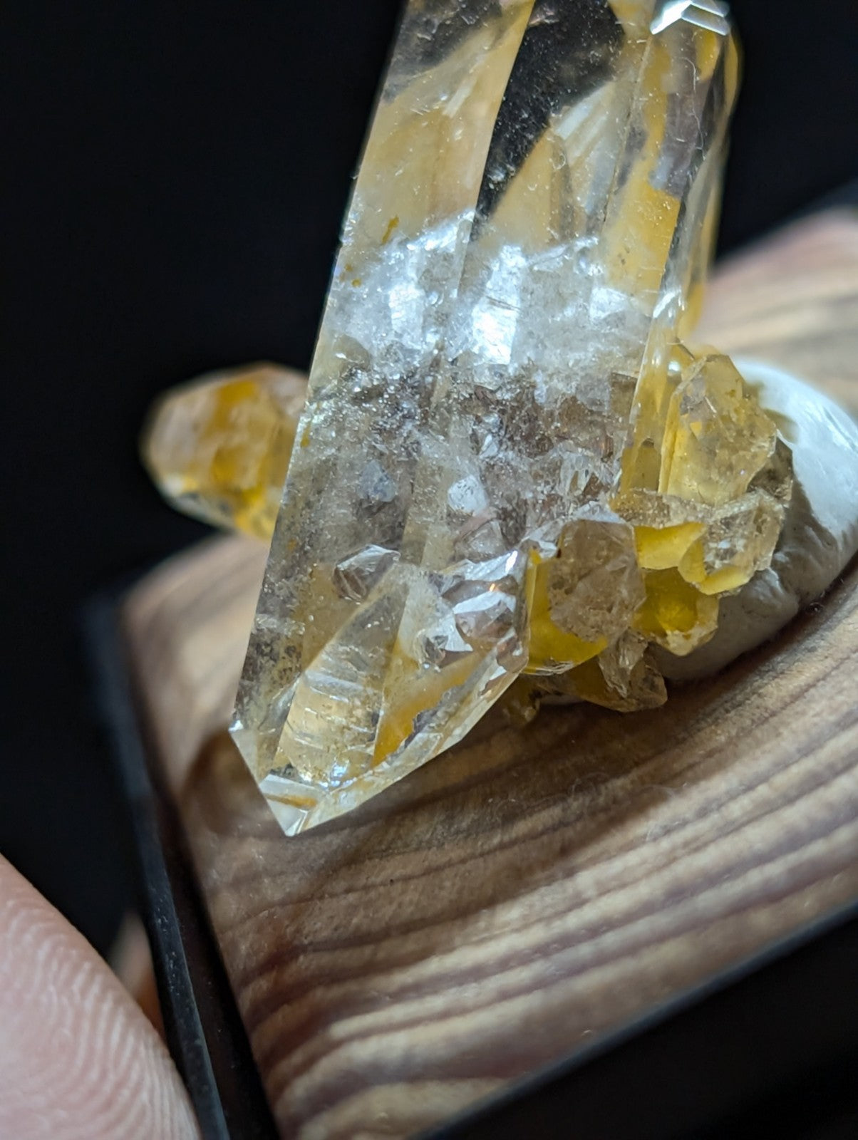 A translucent yellow quartz crystal cluster with sharp, faceted points and embedded golden-yellow inclusions.