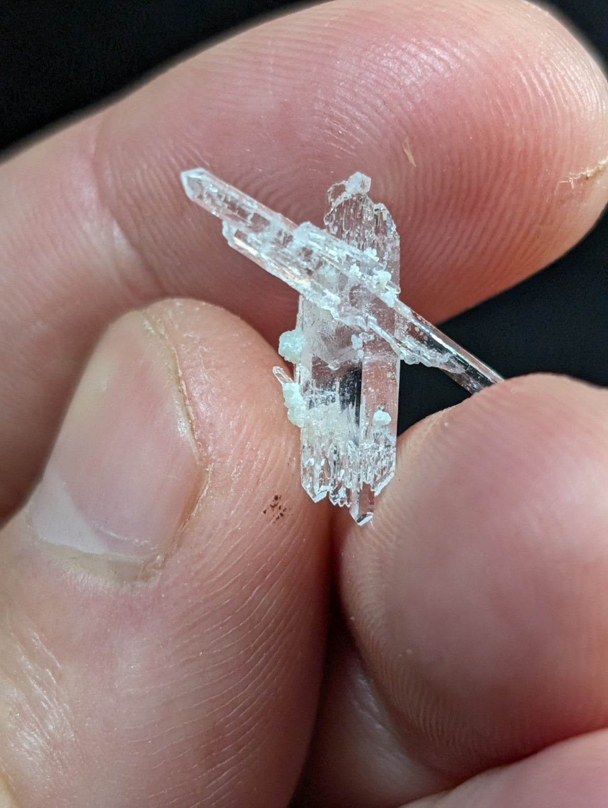 A clear, translucent quartz crystal cluster with sharp, angular facets and a natural, irregular growth pattern.