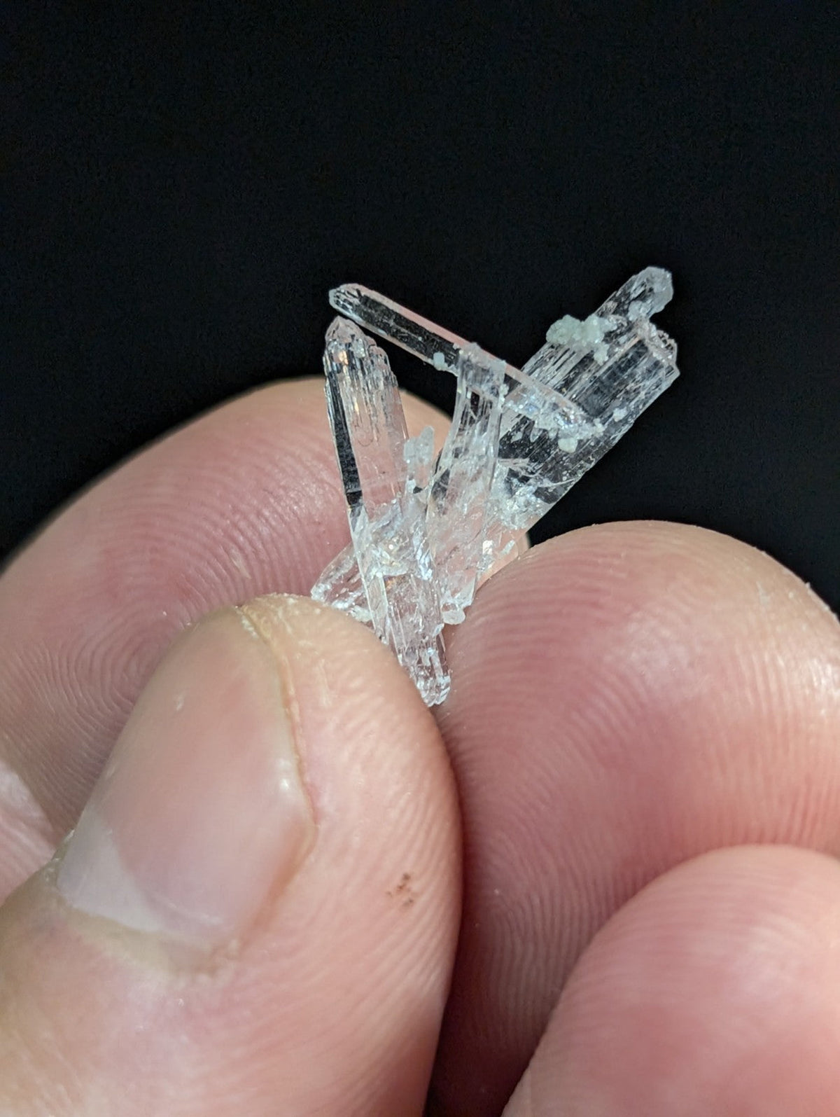 A clear, translucent quartz crystal cluster with multiple interlocking prismatic points.