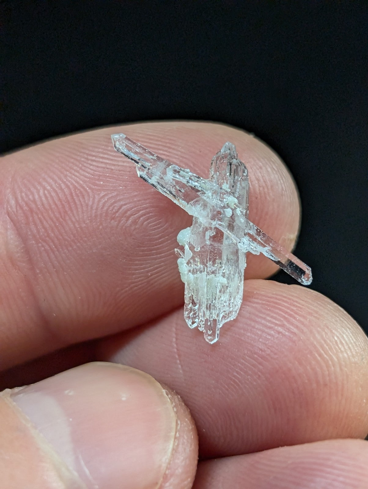 A translucent, crystalline mineral specimen with jagged edges and a clear, glassy appearance.