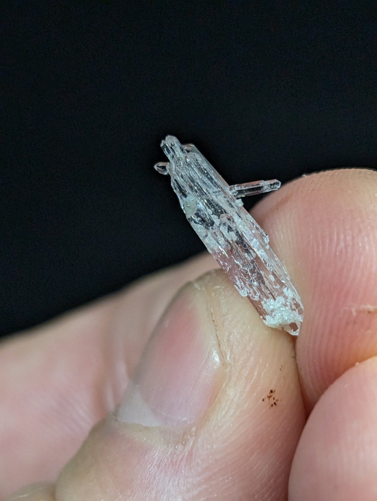 A translucent, clear quartz crystal with a rough, natural texture and visible internal inclusions.