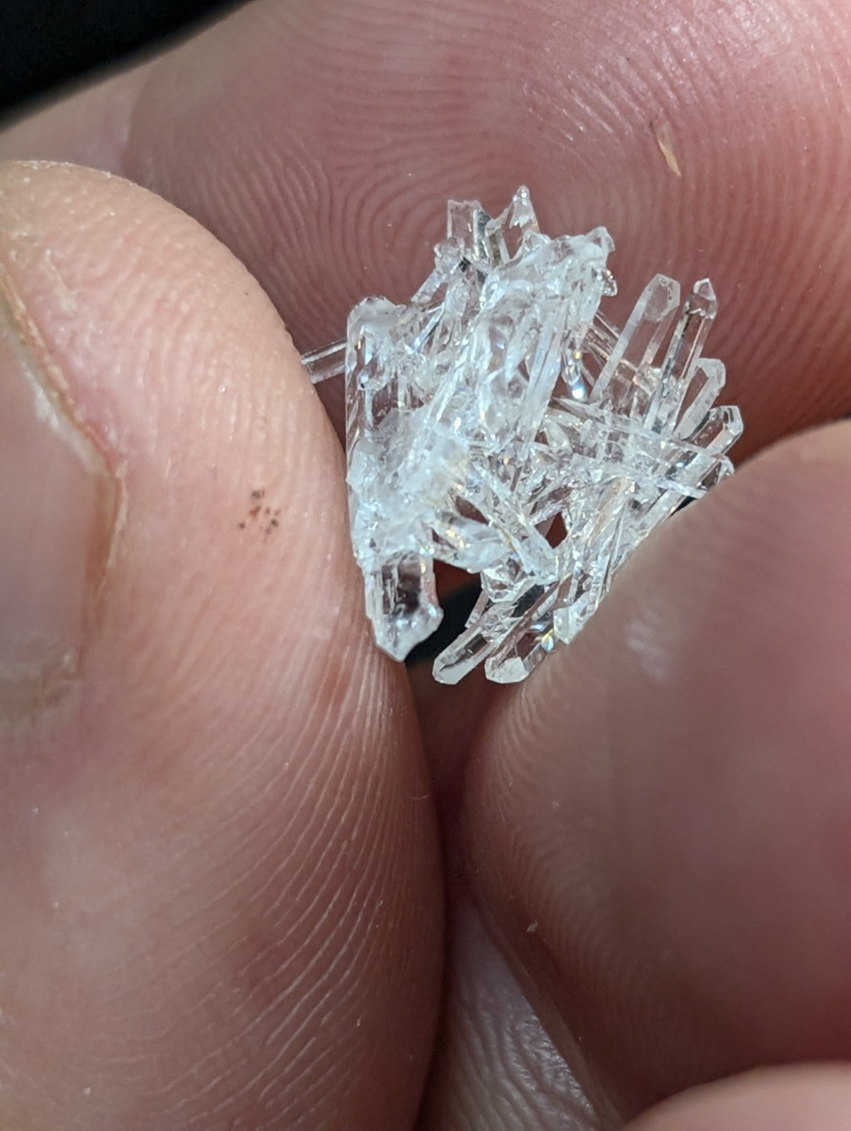 A clear, transparent quartz crystal cluster with sharp, jagged edges and a natural, irregular formation.