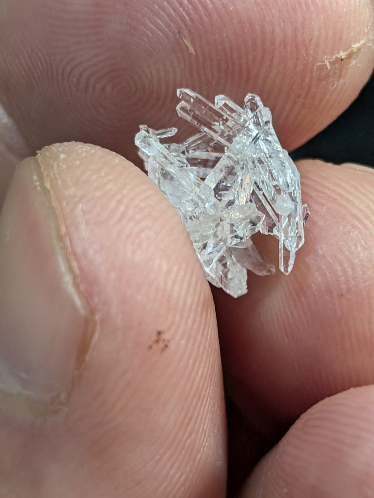 A clear, translucent crystal cluster with sharp, jagged edges and a natural, irregular formation.