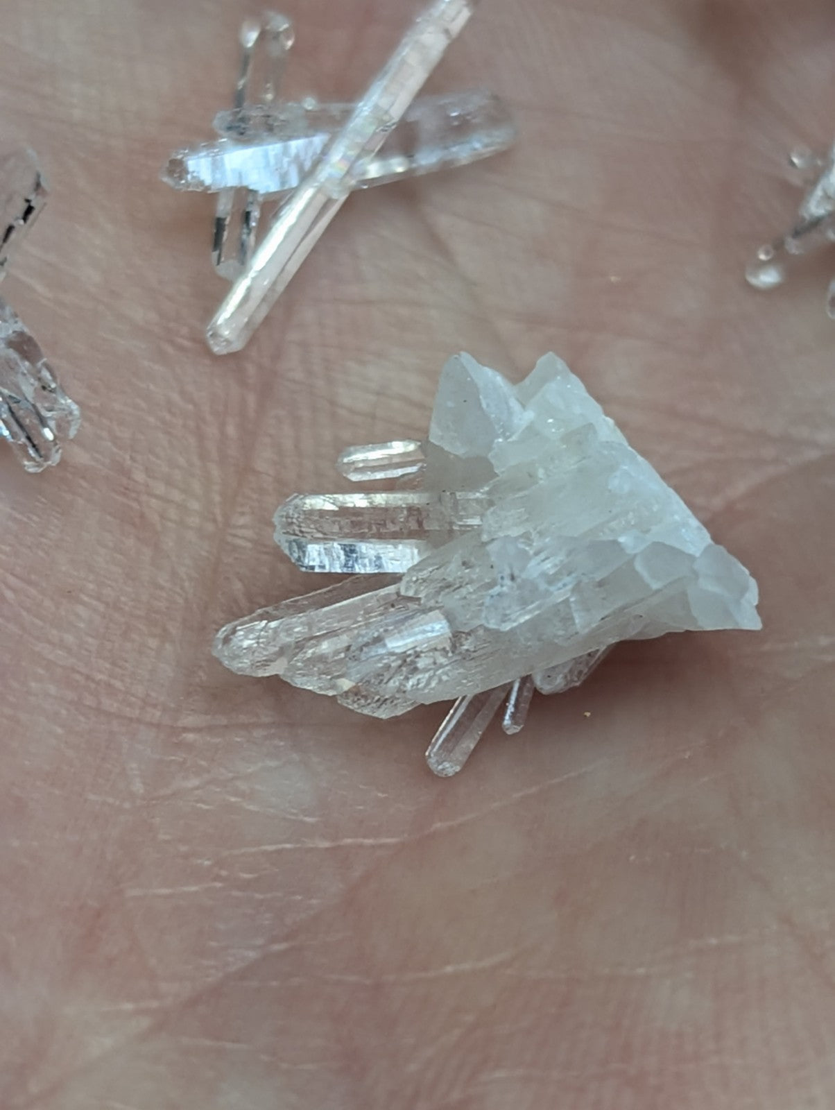 A clear quartz crystal cluster with sharp angular facets in a set of 8 unique forms from jeffrey quarry arkansas