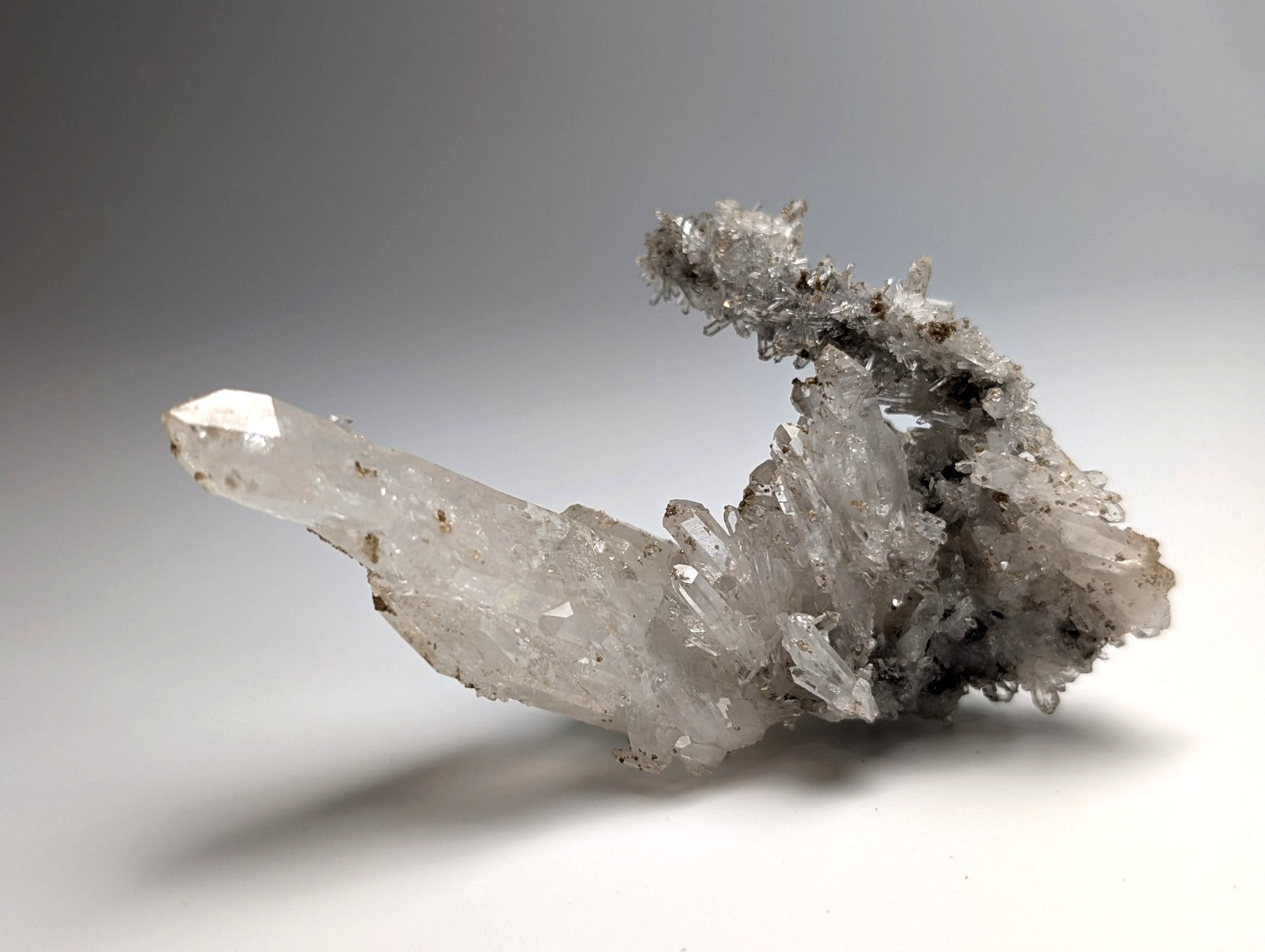 A translucent quartz crystal cluster with a clear point and uv reactive cookeite from jeffrey quarry arkansas rare
