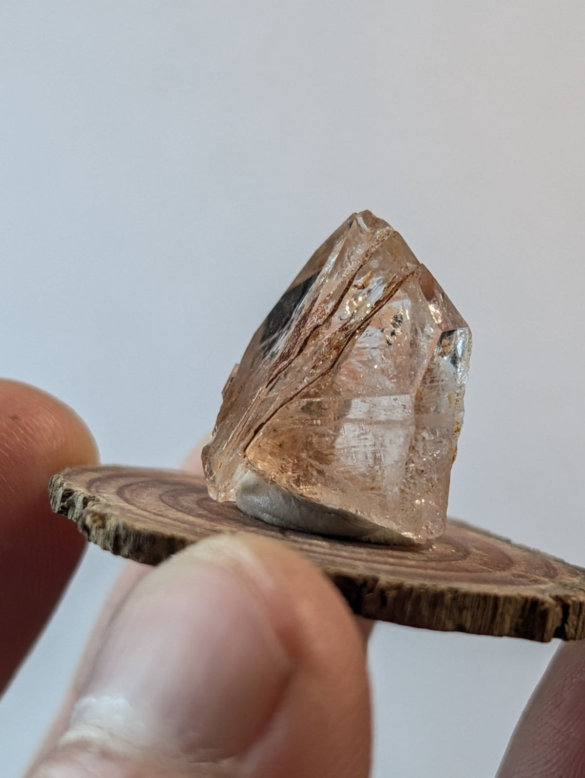 A translucent, amber-hued quartz crystal with natural facets and internal inclusions.