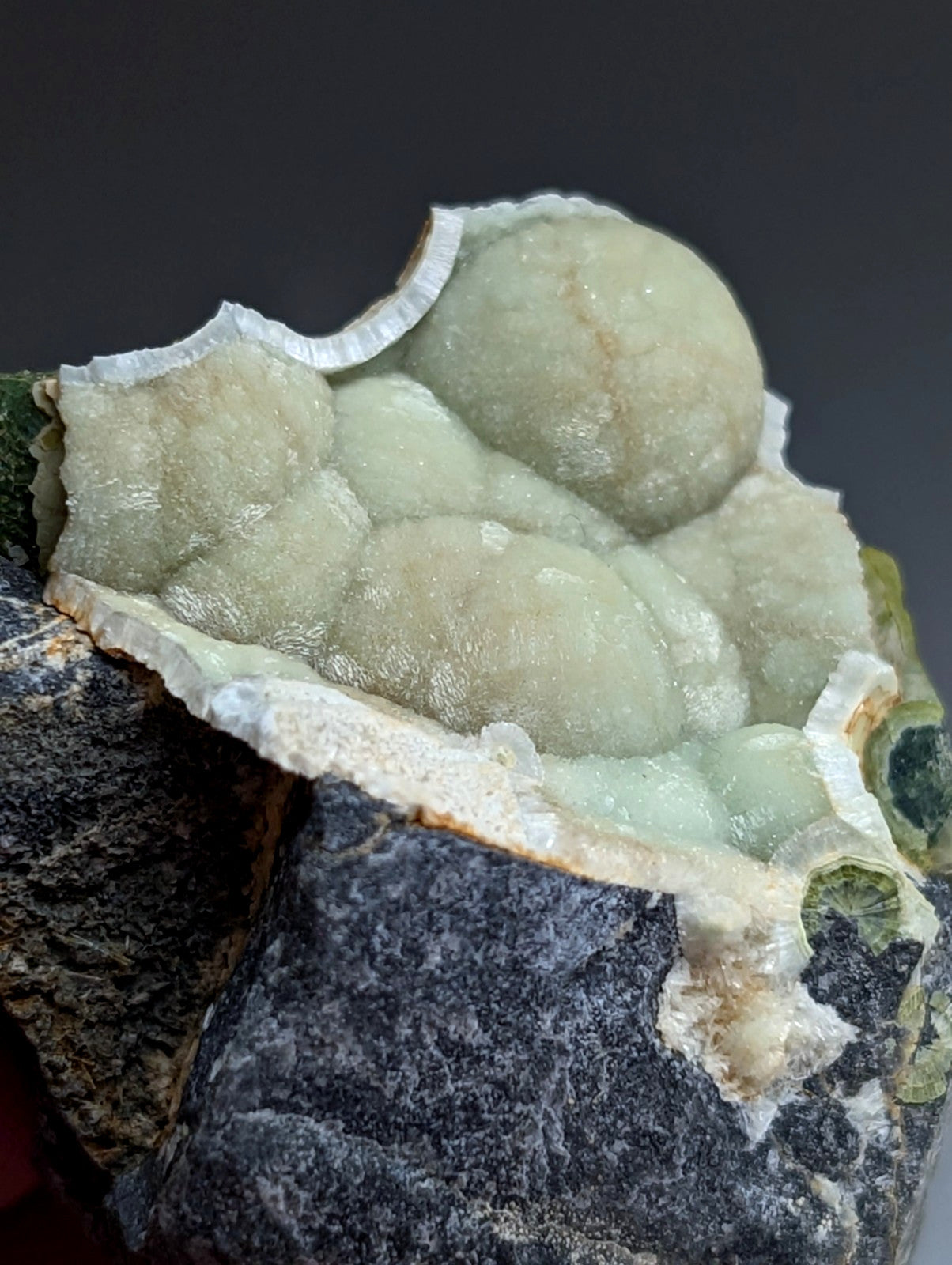 A+ uv reactive wavellite mineral with translucent pale green bubbly clusters and white crystalline edges from Arkansas