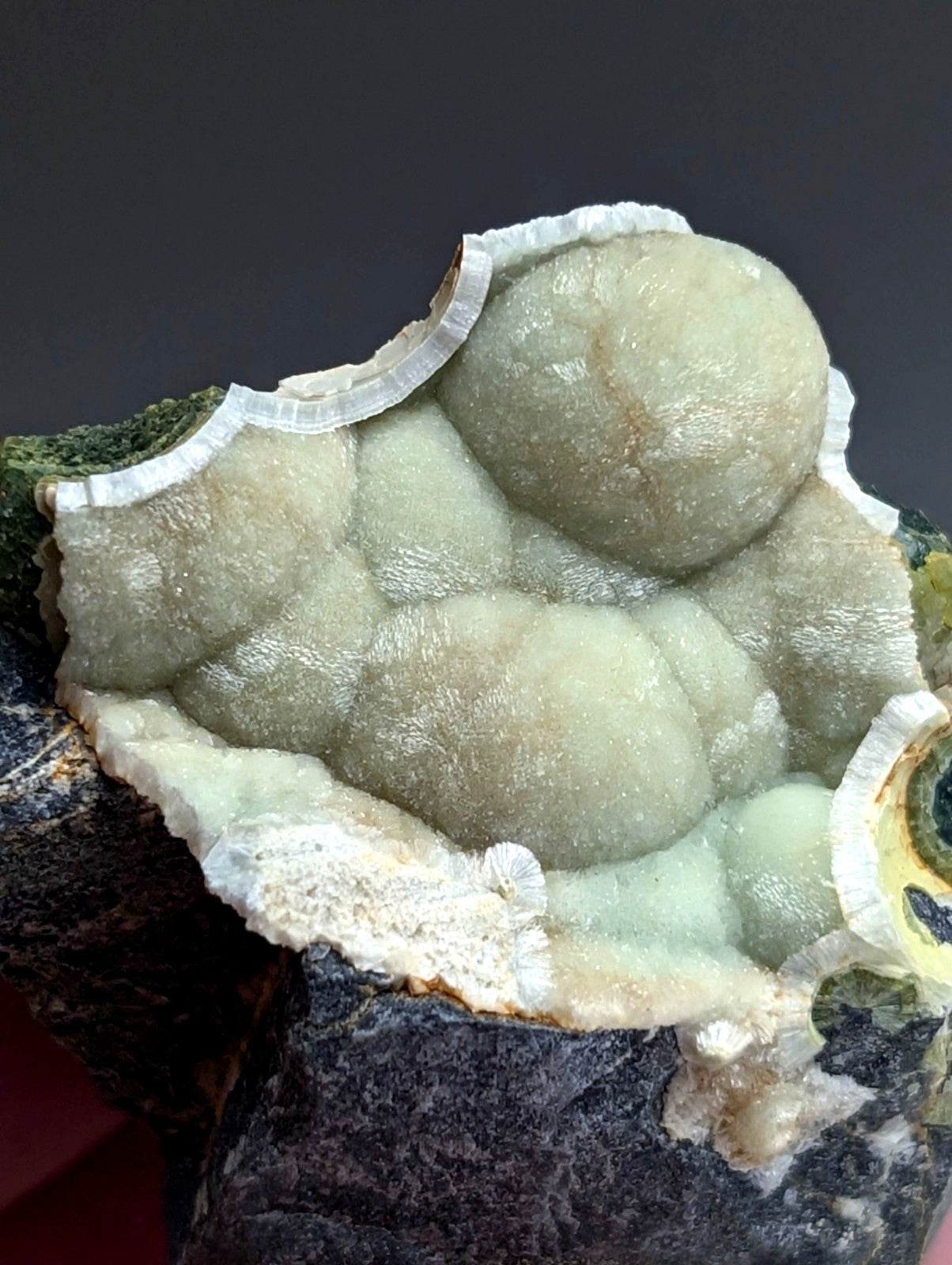 A pale green translucent uv reactive wavellite mineral with rounded bubble formations and crystalline edge from mauldin mountain arkansas usa