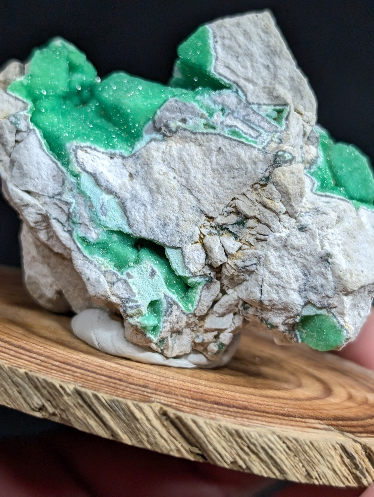 A striking green and gray mineral specimen with crystalline formations, showcasing a natural, rugged texture.