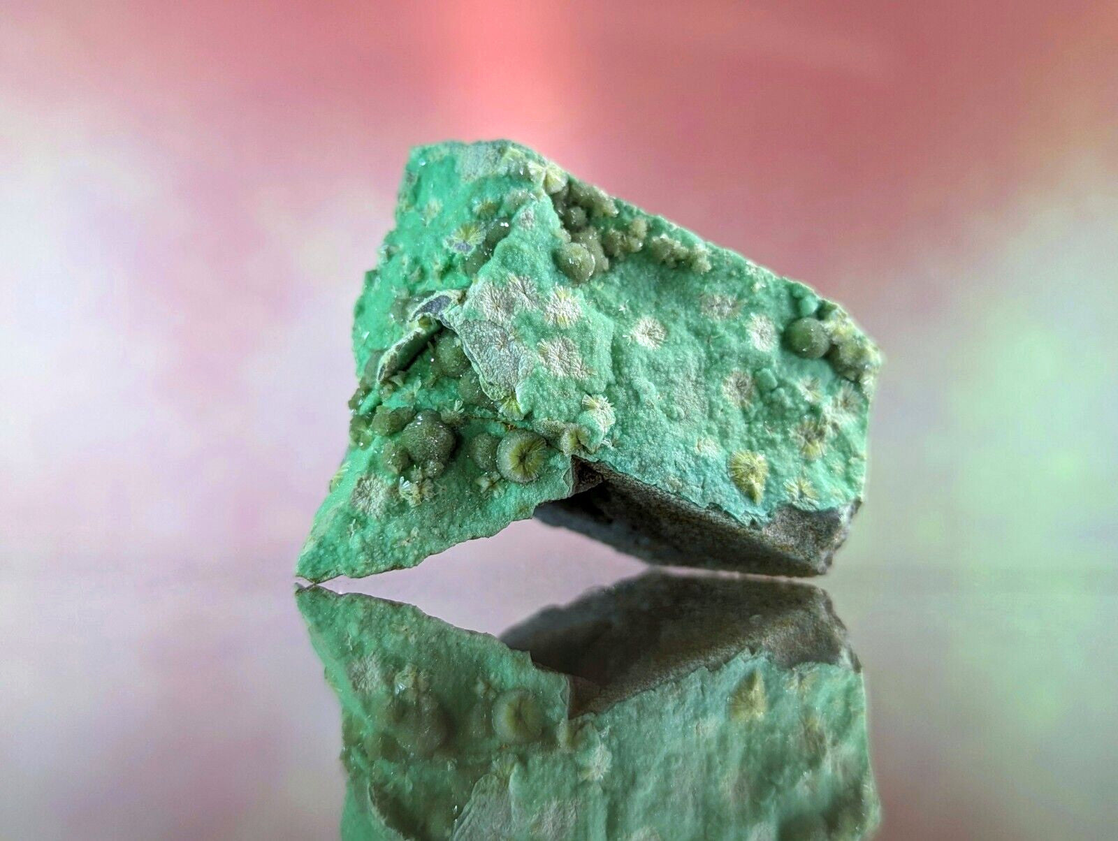 A rough, irregularly shaped piece of green copper patina with small rounded nodules and patches of lighter mineral deposits.
