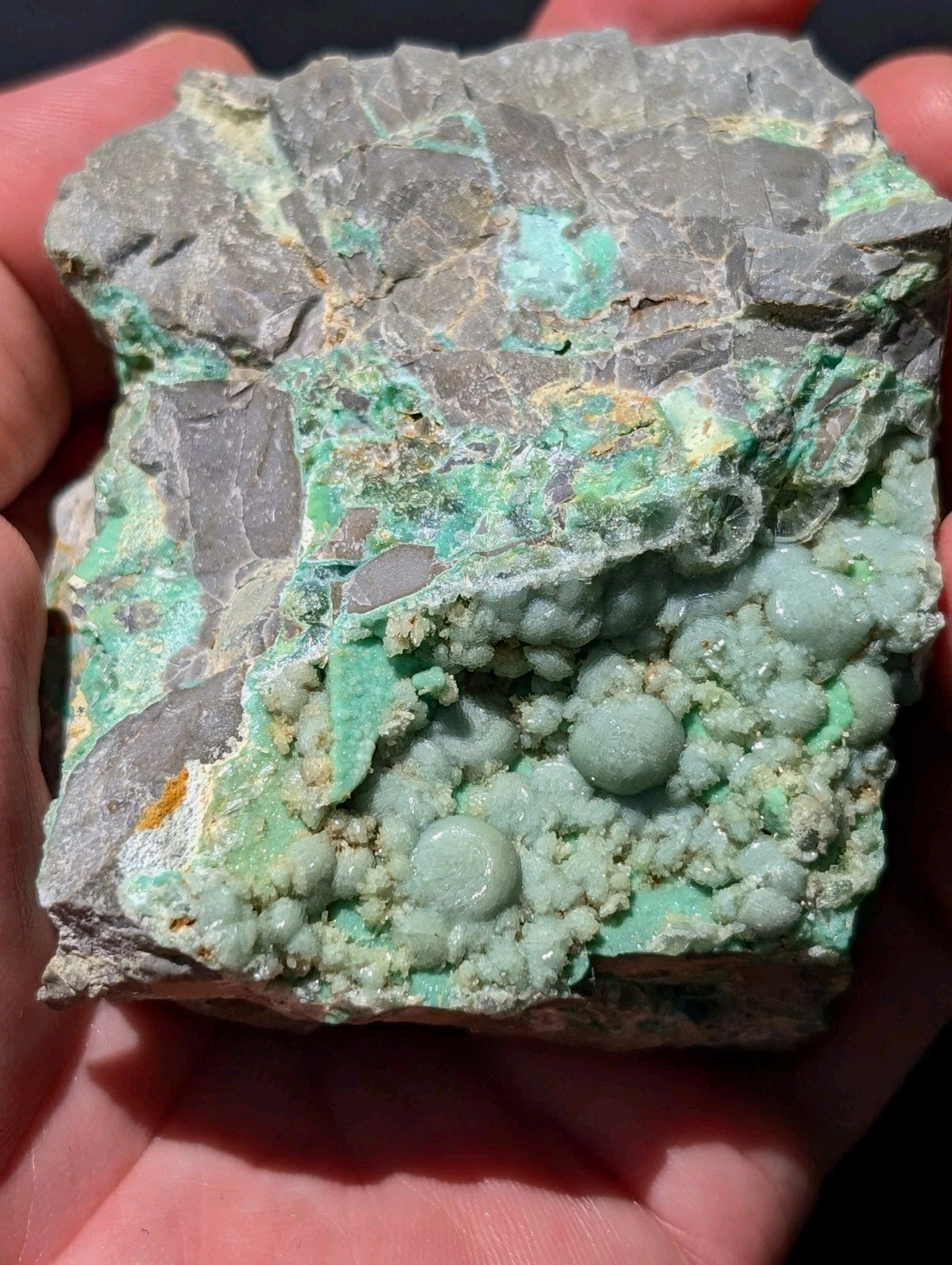 A rugged, irregularly shaped mineral specimen featuring a striking combination of gray rock and vibrant green veining with rounded, bulbous formations.