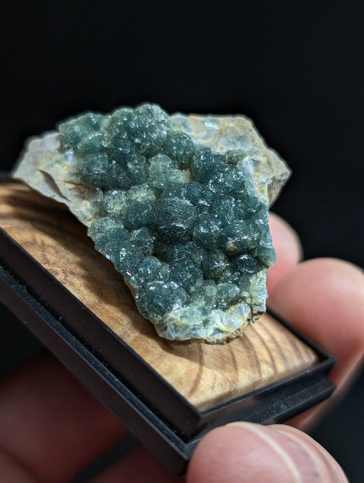 A vibrant green, crystalline mineral specimen with a textured surface and translucent quality.