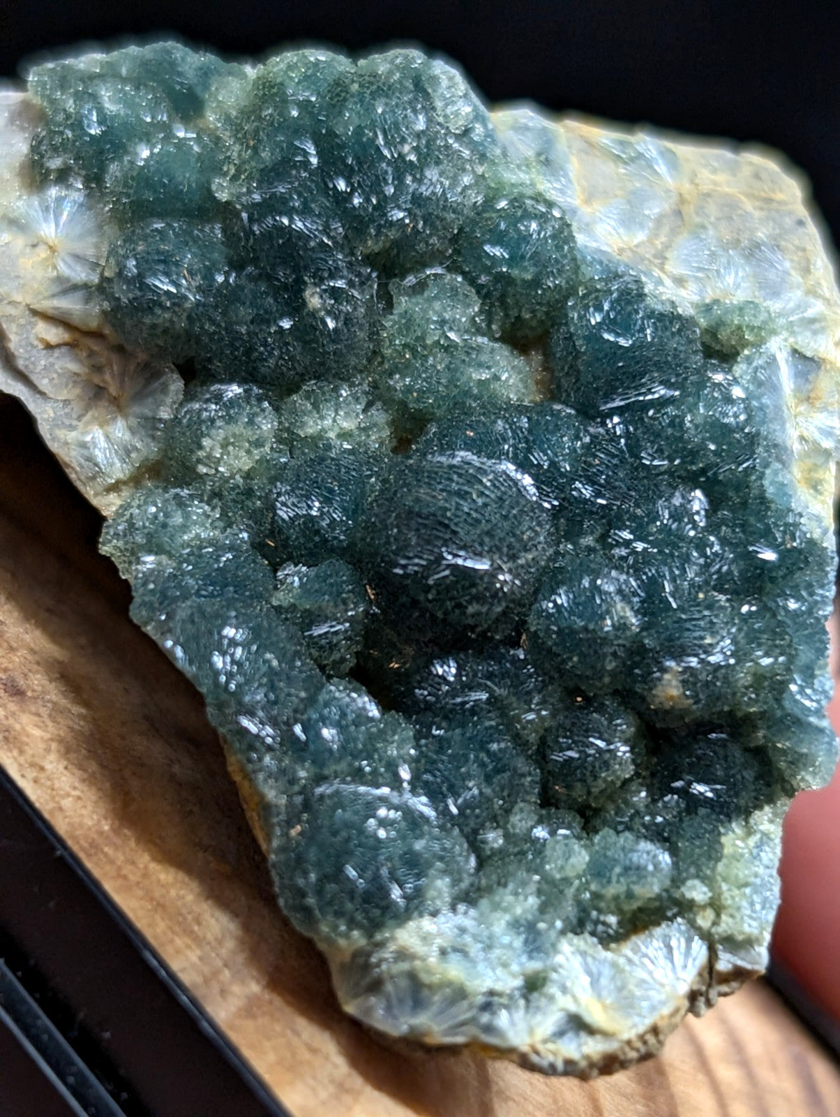 A vibrant green fluorite crystal cluster with a rough, textured surface and translucent facets.