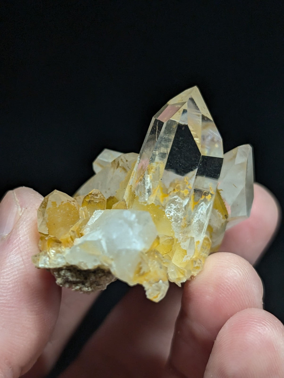 A translucent yellow and clear quartz crystal cluster with a natural, jagged formation.