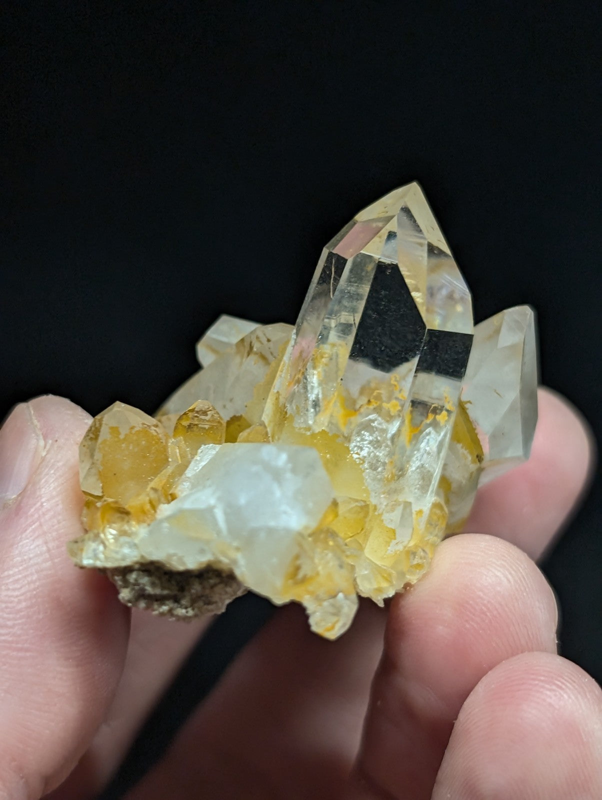 A translucent yellow and clear quartz crystal cluster with a natural, jagged formation.
